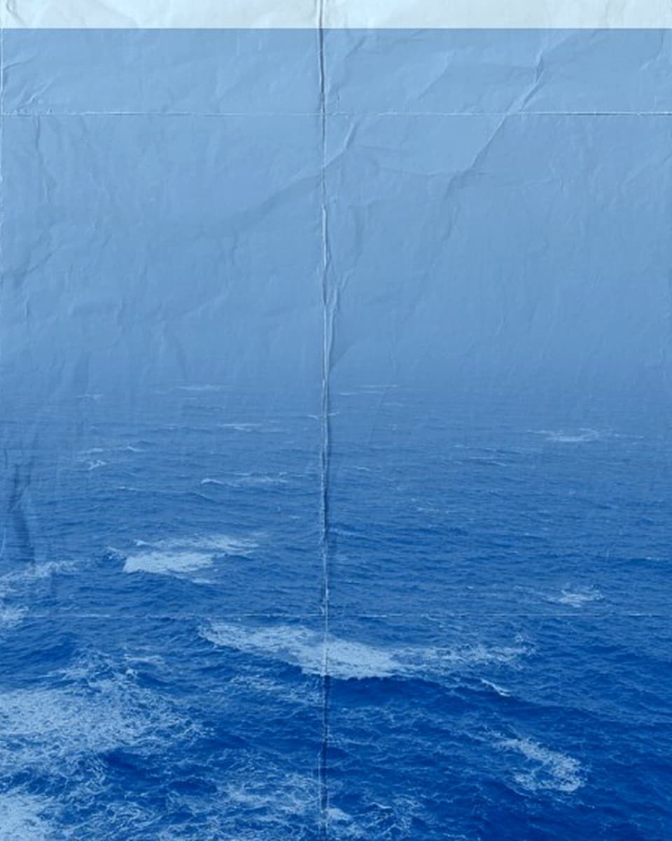 Discover: misty blue horizon over a crumpled seascape